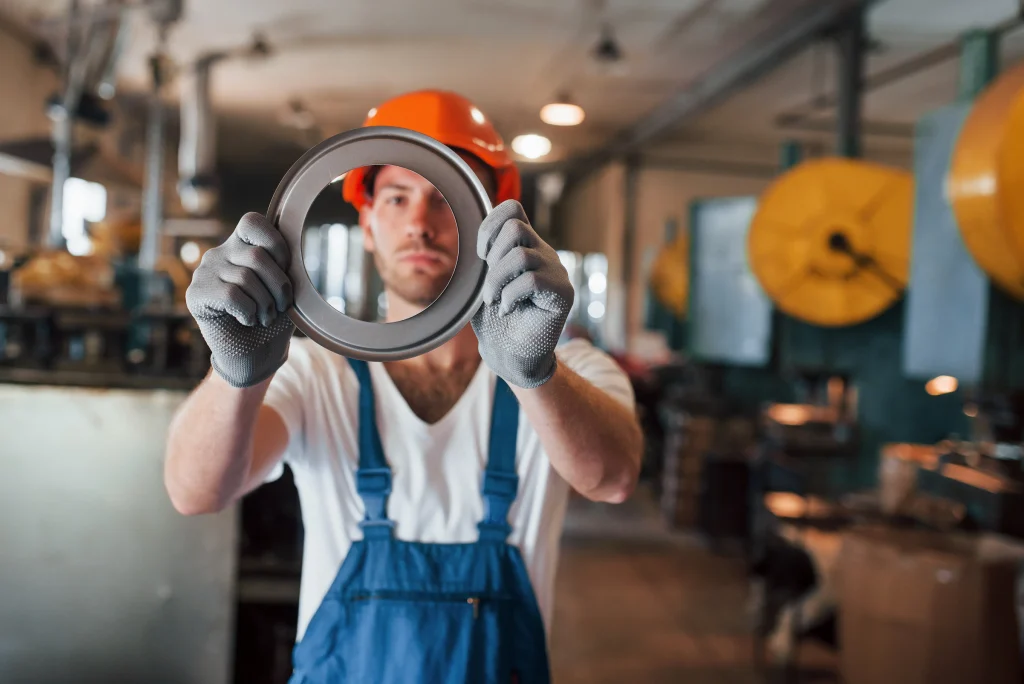 Fotografía de un hombre que trabaja en una industria analizando uno de los retenes de ATI Refacciones